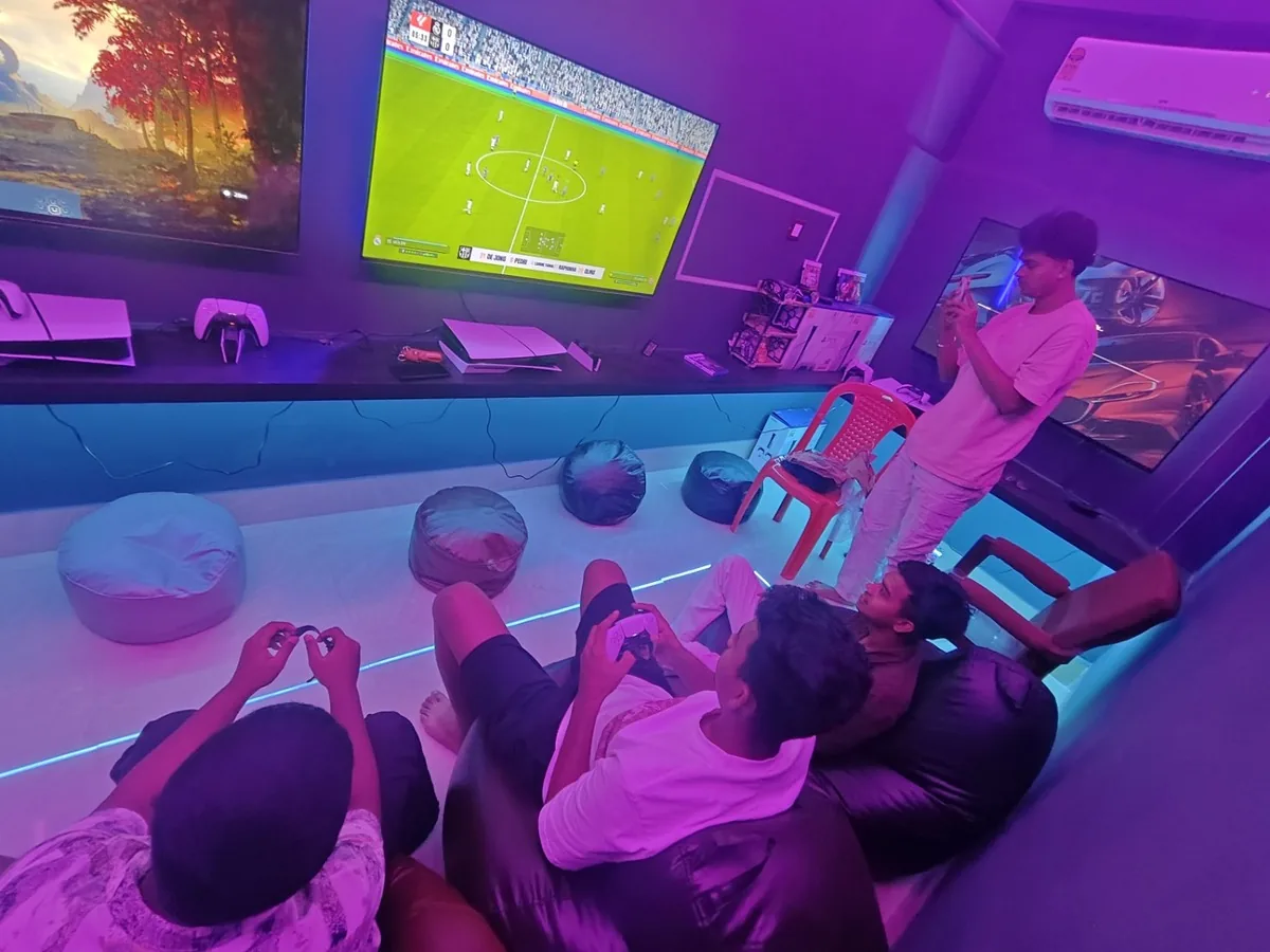 Friends playing a football game on PS5 at Mahakaal Gaming Arena
